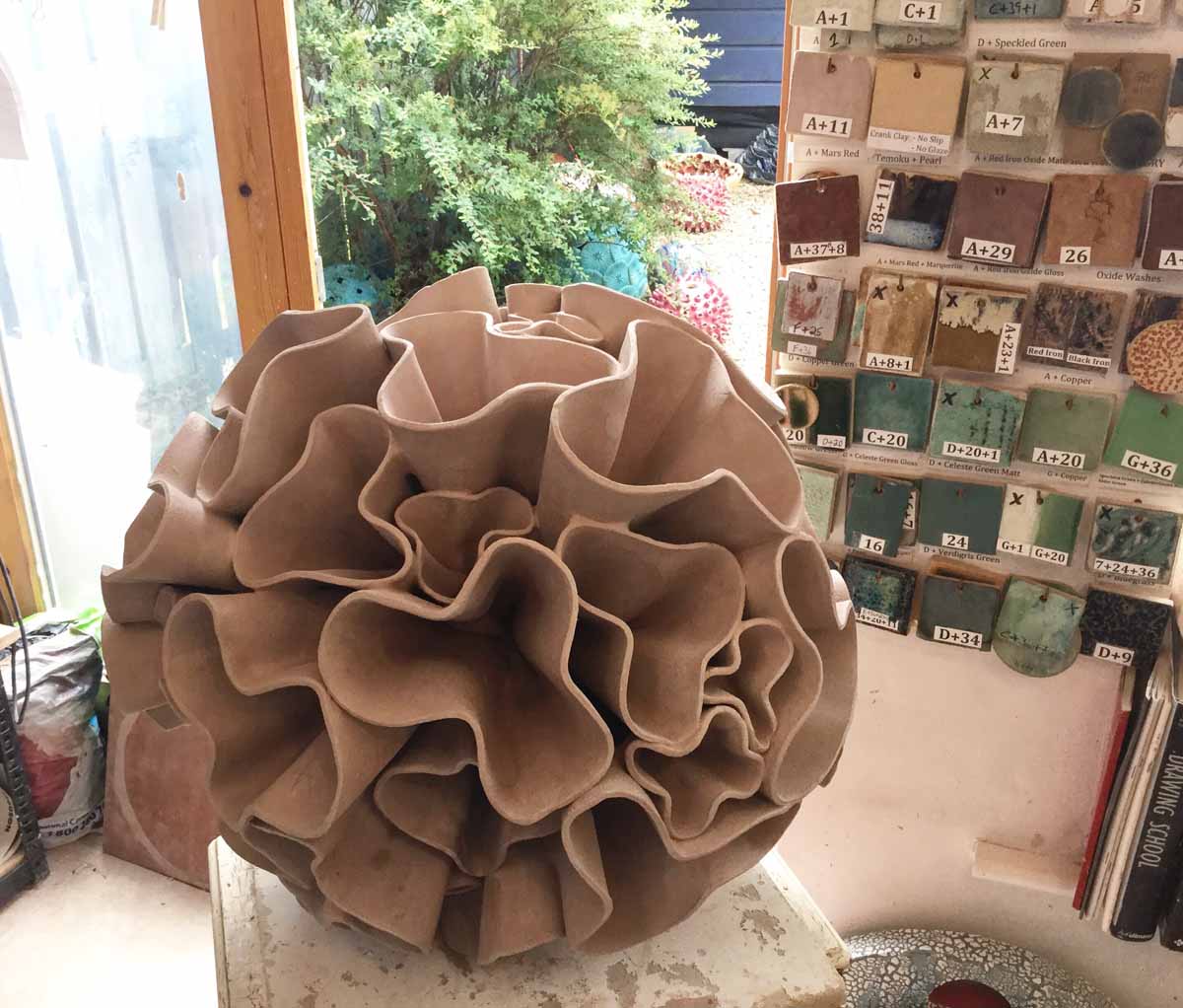 Ceramic water sculpture 'Synthesis' by Michelle Maher. Studio process - here we see my 'Synthesis' sculpture drying in my studio before firing. Each bracket was sculpted individually. To be exhibited at Sculpture in Context 2016 at The National Botanic Gardens in Dublin. Inspired by Dahlia and Coral forms, it was handmade in my own grogged paper clay body and high fired in an electric kiln to 1260°C (Cone 8). www.ceramicforms.com