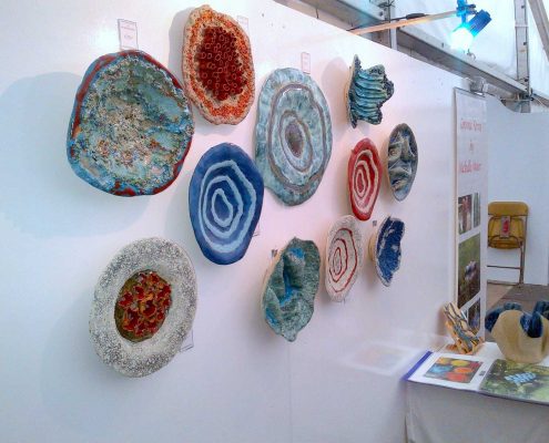 Collection of ceramic wall pieces by Michelle Maher at Art in Action 2014 at Farmleigh House, Dublin. They were hand built and modelled in a grogged stoneware clay body and fired in an electric kiln to 1260°C (Cone 8).See www.ceramicforms.com.